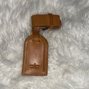 2. Louis Vuitton Vachetta Handle Keeper and Luggage tag with brass accents.